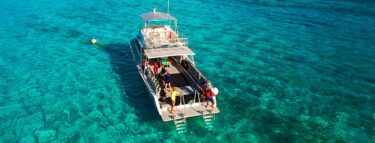 little cayman dive boat on reef 1060x403 min